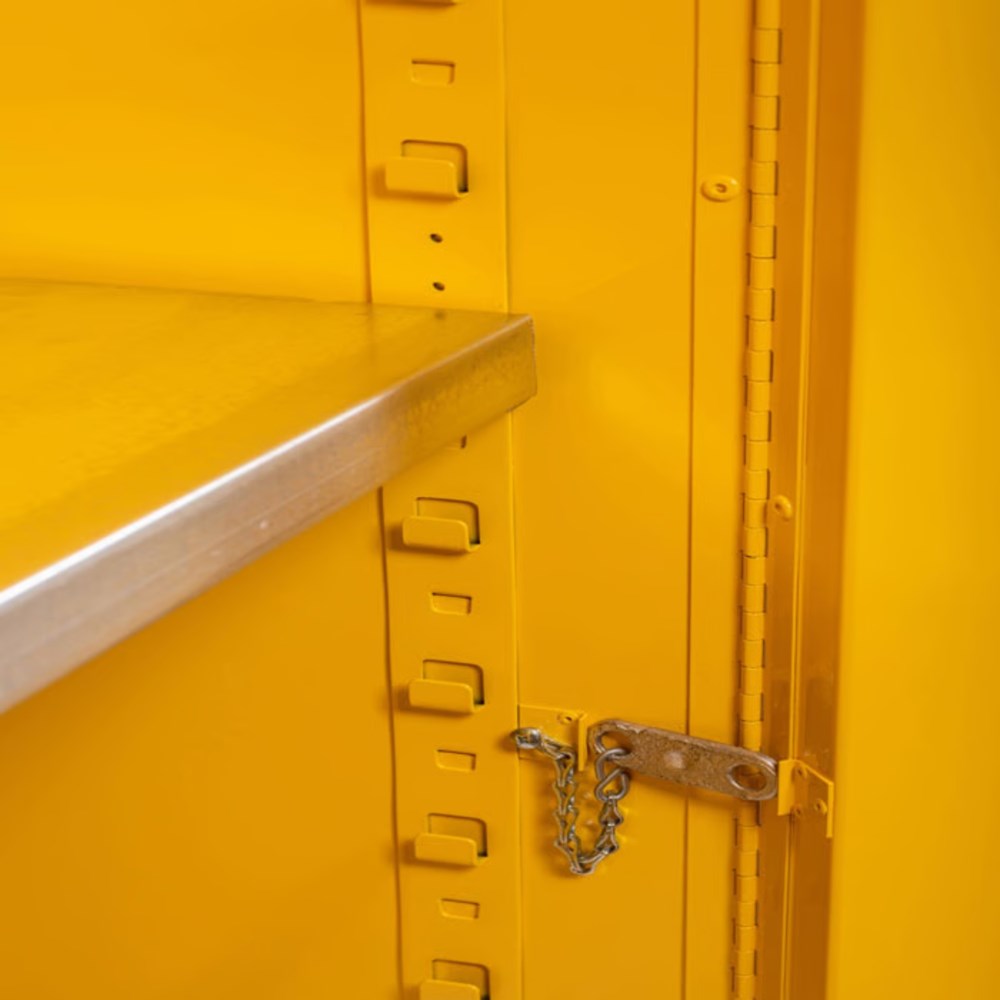 Yellow 22-gauge flammable safety cabinet by Justrite for storing hazardous materials, with a manual close door.
