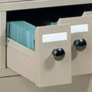 Beige steel stackable slide storage cabinet system by Quincy, showing multiple cabinets with sliding doors and interior shelving.